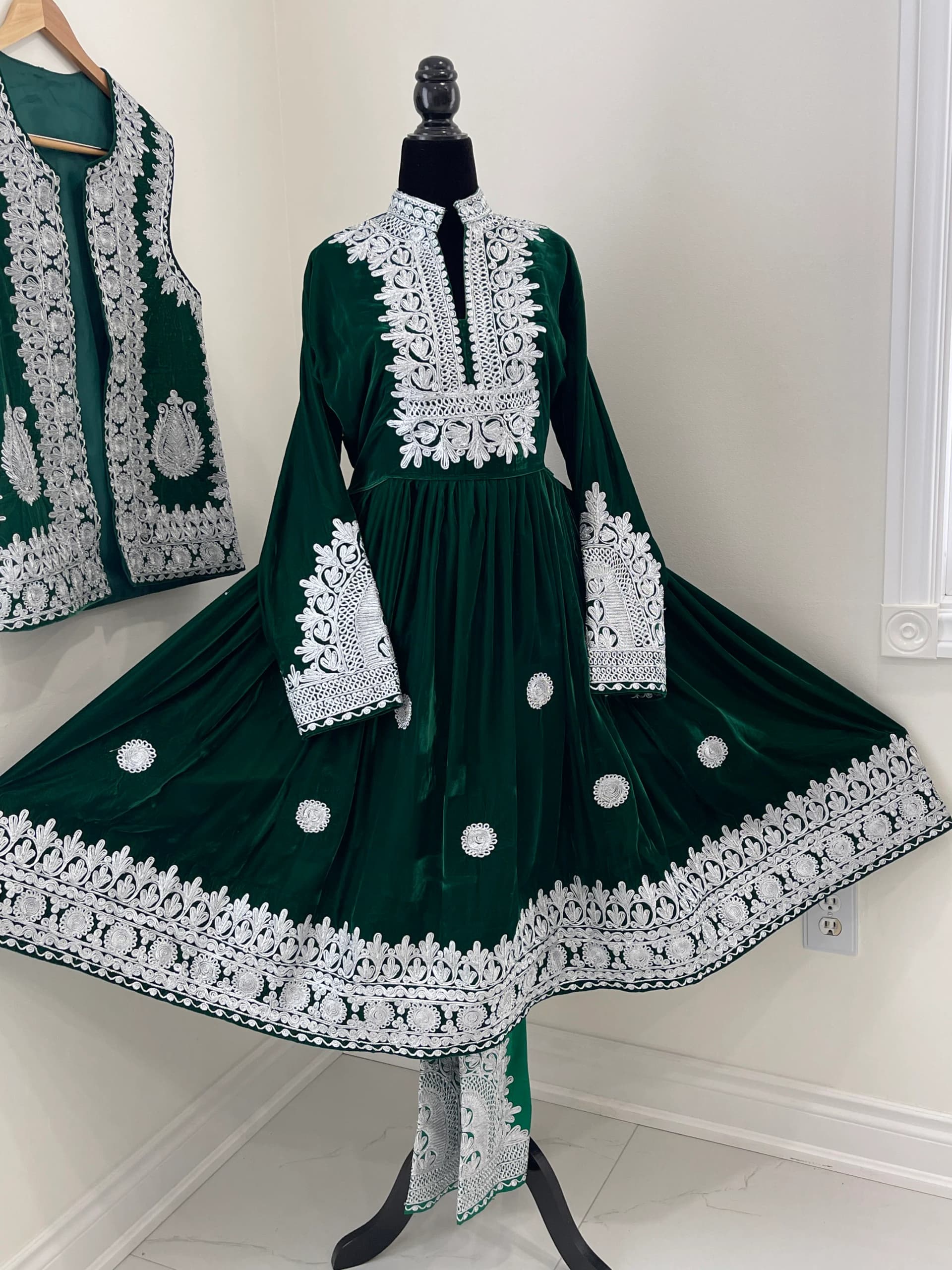 Emerald green velvet Afghan gandi dress with dense ivory hand embroidery.