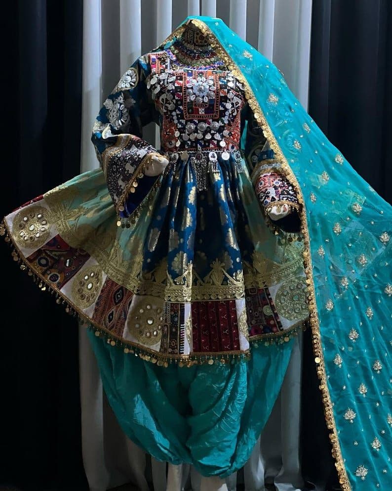 Navy Afghan kuchi dress with mirror and coin work and a turquoise dupatta.